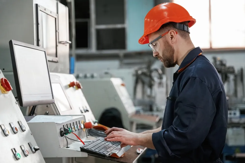 Home 4 Operating,The,Machine.,Factory,Worker,Is,Indoors,With,Hard,Hat.